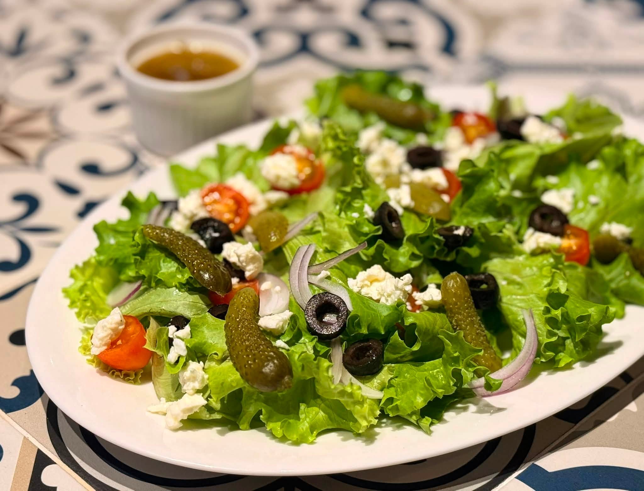 Greek salad with feta, black olives, gherkins and vinaigrette